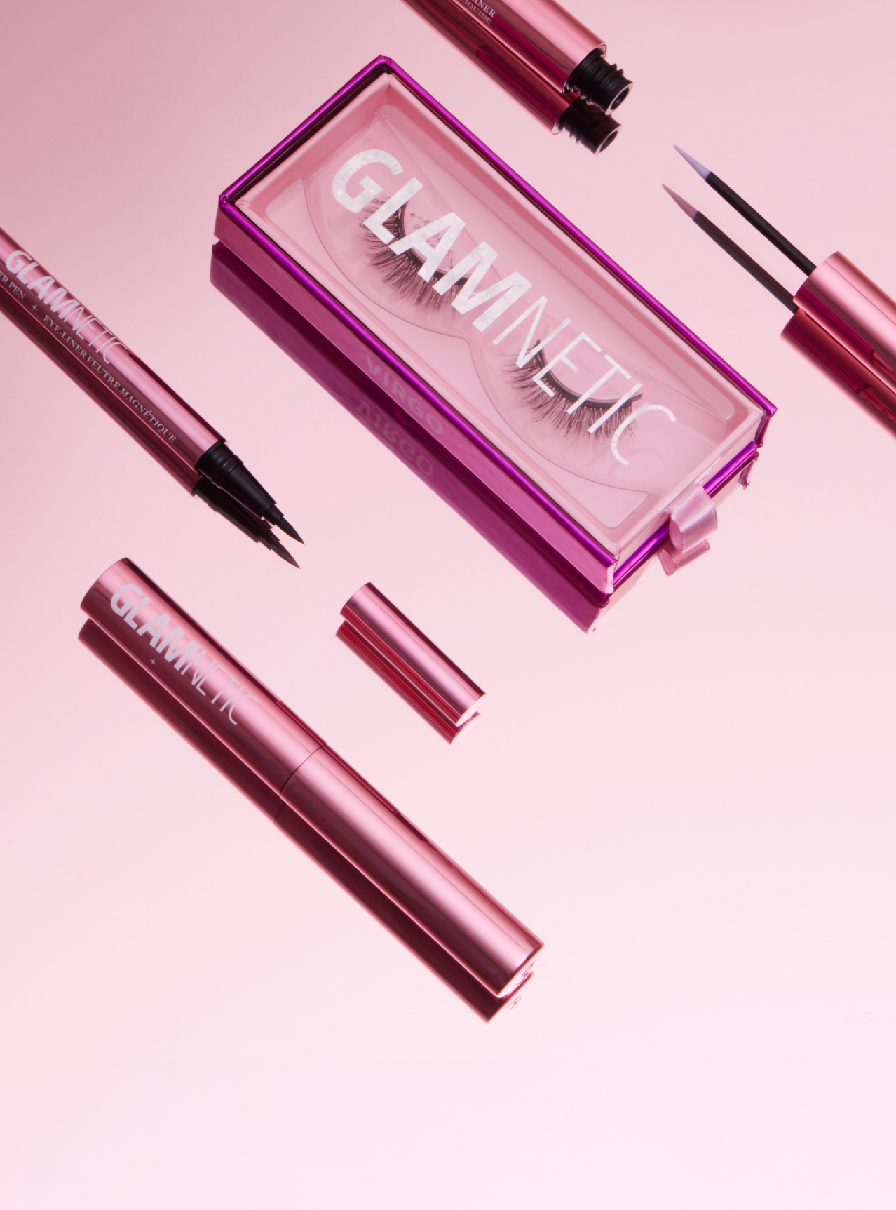 Glamnetic magnetic eyeliner set with pink case on a matching pink background